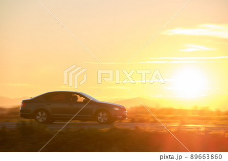 Car driving fast on intercity road at sunset. Highway traffic in evening. Kyiv, Ukraine - June 8, 2021. 89663860