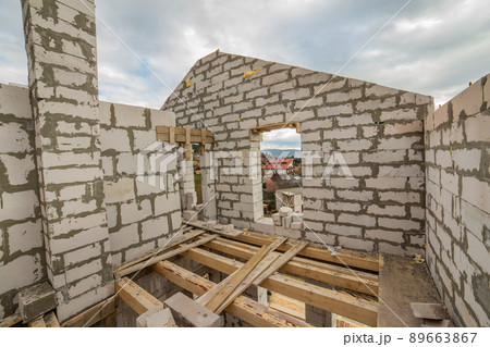 Building site of a house under construction made from white foam concrete blocks. Building site of a house under construction made from white foam concrete blocks. 89663867