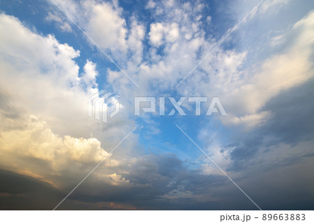 Blue sky covered with white puffy clouds. 89663883