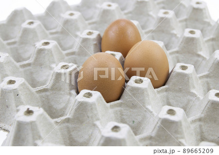 Three chicken eggs in a cardboard egg crate. Three chicken eggs in a cardboard egg crate. 89665209