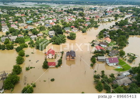 Aerial view of flooded houses with dirty water of Dnister river in Halych town, western Ukraine. Aerial view of flooded houses with dirty water of Dnister river in Halych town, western Ukraine. 89665413
