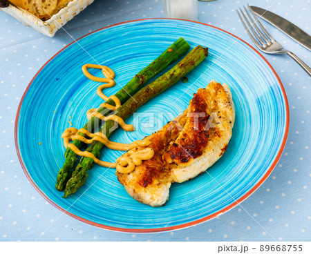 Grilled chicken breast with asparagus and sauce Grilled chicken breast with asparagus and sauce 89668755