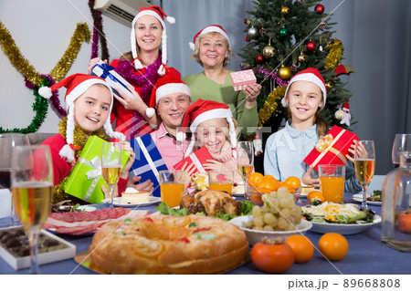 Happy family with kids posing with presents at Christmas 89668808