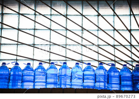 Clean water in plastic bottle moves through conveyor factory. Clean water in plastic bottle moves through conveyor factory. 89670273