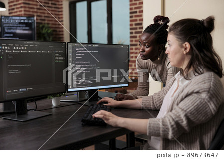 African american team leader looking for unknown anomalies in security network blockchain code. Multicultural development team intensively looking for changes in database storage settings. 89673647