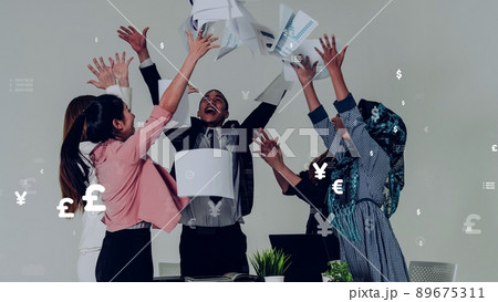 Business people throwing papers in the office with conceptual graphic 89675311