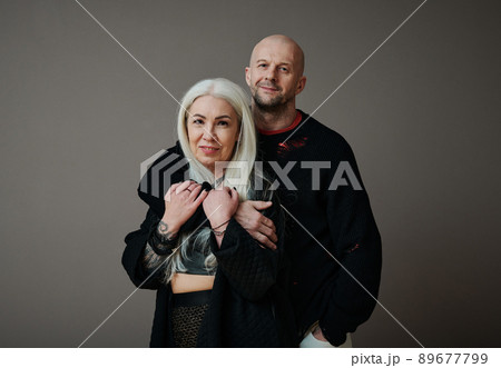 Horizontal medium close-up shot of handsome mature Caucasian man and attractive woman in love wearing stylish clothes looking at camera Horizontal medium close-up shot of handsome mature Caucasian man and attractive woman in love wearing stylish clothes looking at camera 89677799
