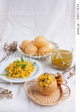 Homemade pani puri, Golgappa Indian snack on cotton calico background Homemade pani puri, Golgappa Indian snack on cotton calico background 89677834