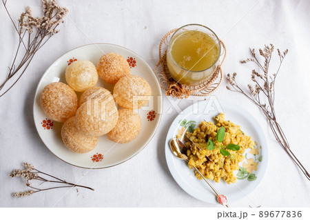 Homemade pani puri, Golgappa Indian snack on cotton calico background Homemade pani puri, Golgappa Indian snack on cotton calico background 89677836