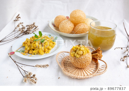Homemade pani puri, Golgappa Indian snack on cotton calico background Homemade pani puri, Golgappa Indian snack on cotton calico background 89677837