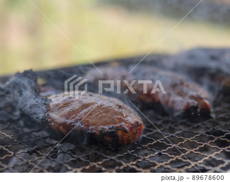 Charred pork meat on the grill Charred pork meat on the grill 89678600