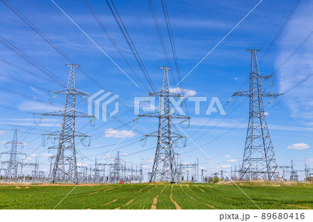 High voltage electricity towers, transmission power lines, cables on transformers, and distribution substation 89680416