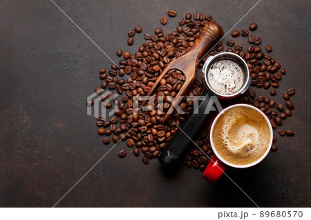 Roasted coffee beans and ground coffee in filter holder 89680570