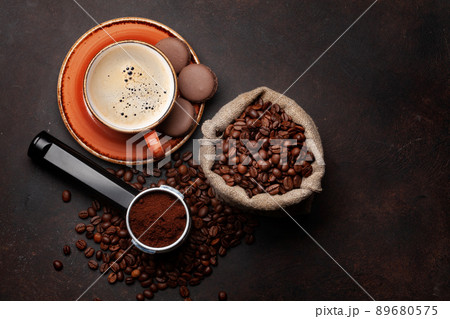 Espresso, roasted coffee beans and ground coffee in holder 89680575
