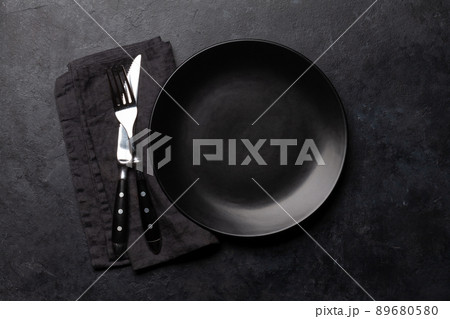 Empty plate and silverware on stone table 89680580