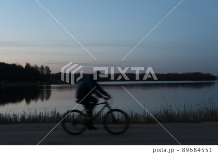 Silhouette of a bicyclist on the beach at sunset Silhouette of a bicyclist on the beach at sunset 89684551
