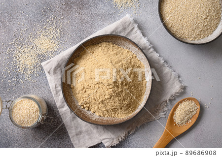 Sesame flour in bowl for cooking vegan gluten-free dessert. Sesame flour in bowl for cooking vegan gluten-free dessert. 89686908