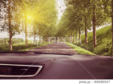 View of the road and forest through the windshield of the car Su 89686947
