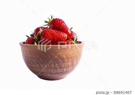 Fresh strawberries in a brown bowl on white background Fresh strawberries in a brown bowl on white background 89691467