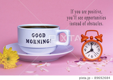 Motivational quote with white coffee cup with alarm clock set at 8 o'clock. 89692684