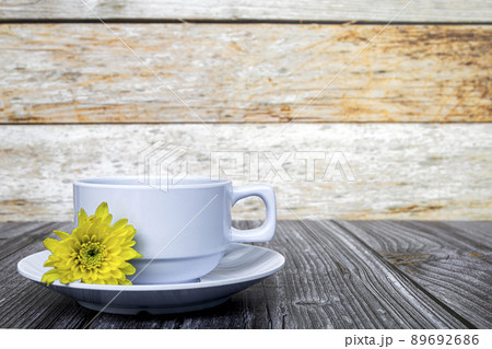 White coffee cup and dahlia flowers on wooden desk. Copy space. White coffee cup and dahlia flowers on wooden desk. Copy space. 89692686