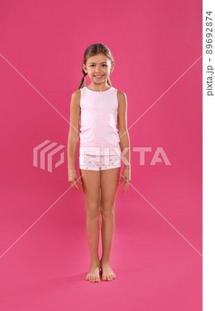 Little girl wearing blue panties with pink hearts stock photo - OFFSET