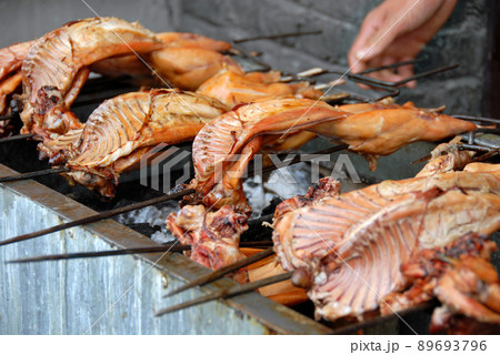 Fenghuang, Hunan Province, China: Meat cooking on a barbecue in Fenghuang. Traditional Chinese street food. Shallow depth of focus. 89693796