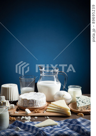 Dairy products on wood base and blue background with copy space. Vertical format. 89695239