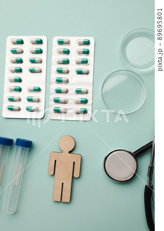 Stethoscope, syringes, blood sample and pills on blue background, healthcare concept. Vertical image Stethoscope, syringes, blood sample and pills on blue background, healthcare concept. Vertical image 89695801