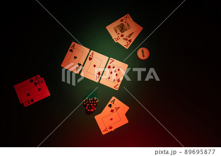 Table with poker game, top view. Dice and playing cards are on a green background 89695877