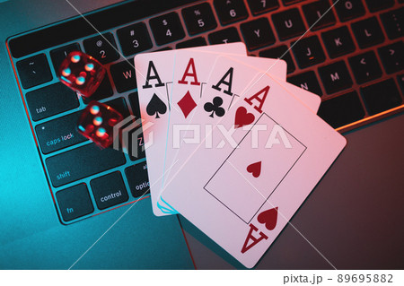 Playing dice and cards on laptop. Online gambling and casino concept Playing dice and cards on laptop. Online gambling and casino concept 89695882