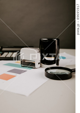 Concept of approvement. Office desktop with documents and stamp. Vertical image Concept of approvement. Office desktop with documents and stamp. Vertical image 89695917