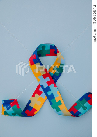 World Autism awareness and pride day with Puzzle pattern ribbon on blue background. Vertical image World Autism awareness and pride day with Puzzle pattern ribbon on blue background. Vertical image 89695942