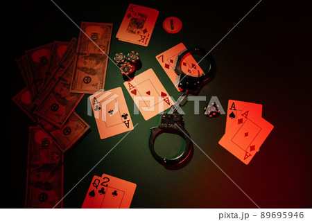Dice, cards and handcuffs on the green table, top view. Casino concept 89695946