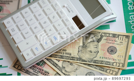 Business report in cash dollars charts and calculator on table 89697293