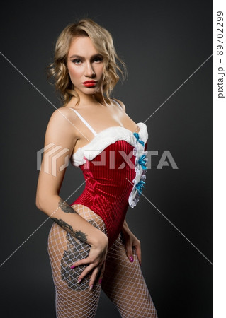 Slim seductive woman portrait in red Snow Maiden costume 89702299