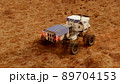 Martian rover drives across the rocky surface, observing the colonists base inside of the crater. 4K footage 89704153