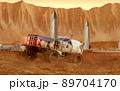 Martian rover drives across the rocky surface, observing the colonists base inside of the crater. 4K footage 89704170