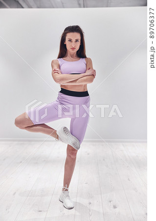 Young beautiful girl stretches before dance class and look at the camera 89706377