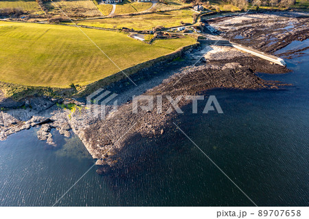 Aerial view of the amazing rocky coast at Ballyederland and pier by Dunkineely in County Donegal - Ireland Aerial view of the amazing rocky coast at Ballyederland and pier by Dunkineely in County Donegal - Ireland 89707658
