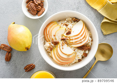 Oatmeal with cottage cheese, pecan nuts and pear for breakfast 89709546