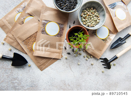 Microgreen seeds in paper bags and equipment for sowing microgreens. Microgreen seeds in paper bags and equipment for sowing microgreens. 89710545