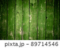 Old wooden green background of boards with cracked and peeling paint. Wooden texture. Fence 89714546