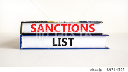 Sanctions list symbol. Books with concept words Sanctions list on beautiful white background. Business political sanctions list concept. Copy space. Sanctions list symbol. Books with concept words Sanctions list on beautiful white background. Business political sanctions list concept. Copy space. 89714595