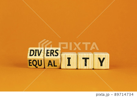 Diversity and equality symbol. Turned wooden cubes and changed the word 'equality' to 'diversity'. Beautiful orange background. Business, diversity and equality concept. Copy space. Diversity and equality symbol. Turned wooden cubes and changed the word 'equality' to 'diversity'. Beautiful orange background. Business, diversity and equality concept. Copy space. 89714734