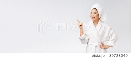 Beauty portrait of young woman showing and pointing finger to empty copy space, asian beauty in bathrobe. 89723049
