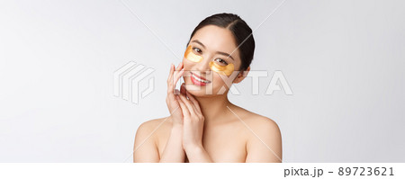 Asian beauty teenager woman care her skin with gold eye masks patches under eyes Asian beauty teenager woman care her skin with gold eye masks patches under eyes 89723621