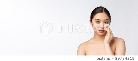 skin care woman removing face makeup with cotton swab pad - skin care concept. Facial closeup of beautiful mixed race model with perfect skin. skin care woman removing face makeup with cotton swab pad - skin care concept. Facial closeup of beautiful mixed race model with perfect skin. 89724219