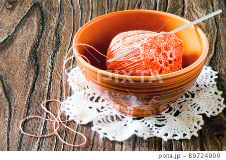 Cotton yarn and hook into a bowl. Needlework accessories. Cotton yarn and hook into a bowl. Needlework accessories. 89724909