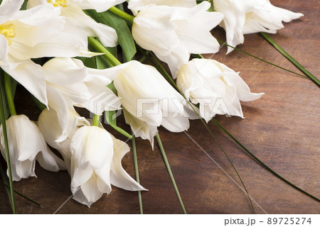 Bouquet of white tulips on old wooden boards. Bouquet of white tulips on old wooden boards. 89725274